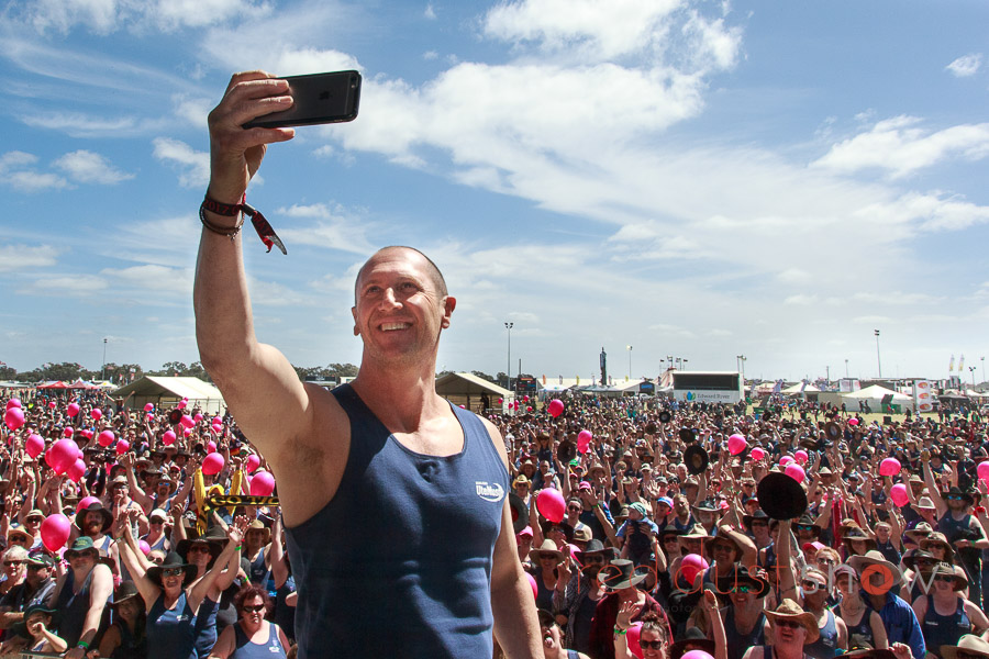 The crowd at the Deni Ute Muster watching TV personality Larry Emdur take a selfie with the audience in the background, Deniliquin, NSW, Australia