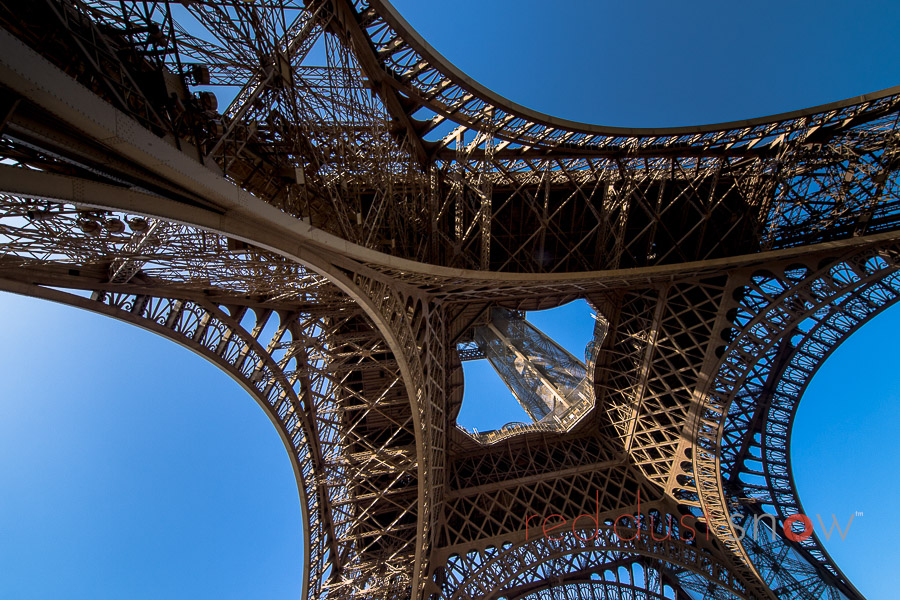 Photograph of the Eiffel Tower from underneath the eastern span — La Tour Eiffel, Paris, France